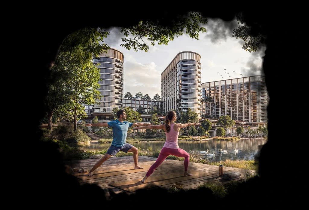Sobha Sanctuary — residents practicing yoga on a lakeside wellness deck with swans on the water and curved luxury apartment towers in the background